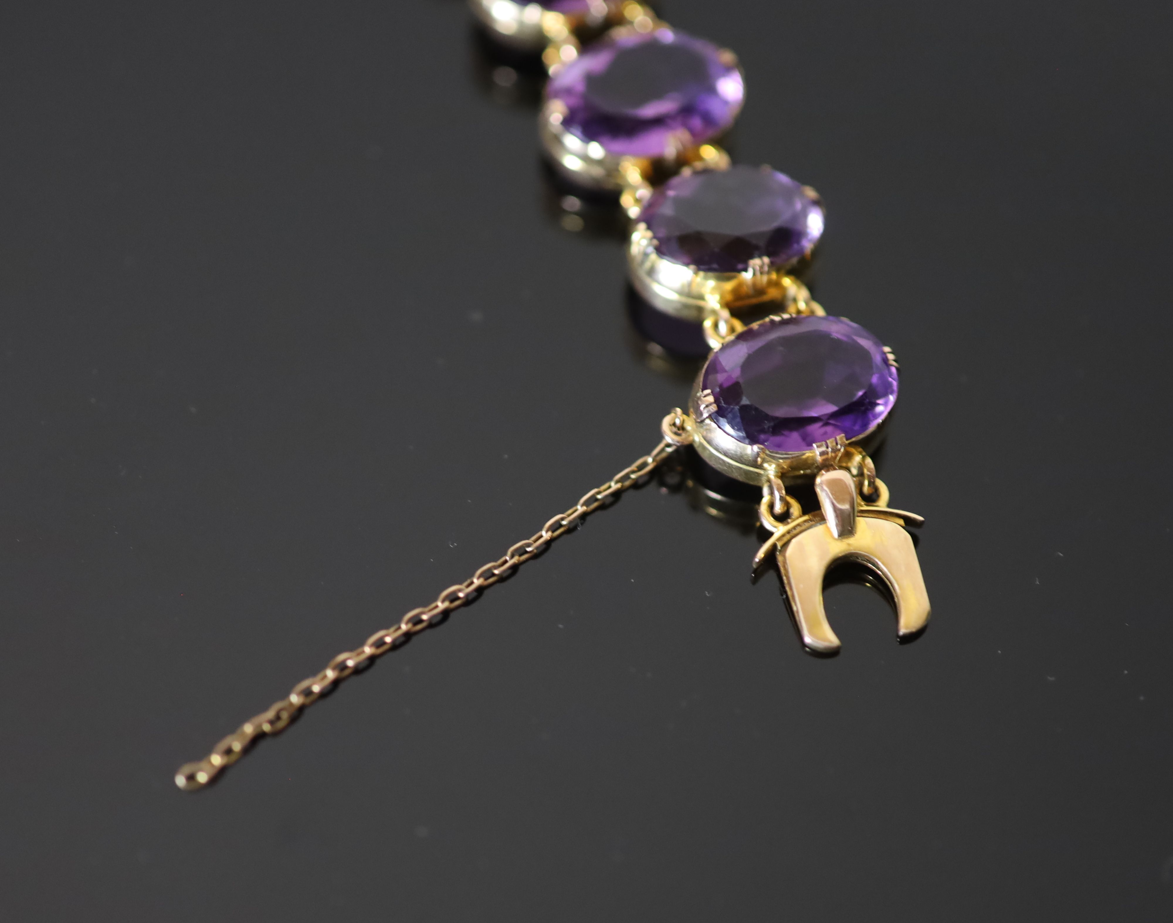 A Victorian style gold and ten stone oval cut amethyst set bracelet,